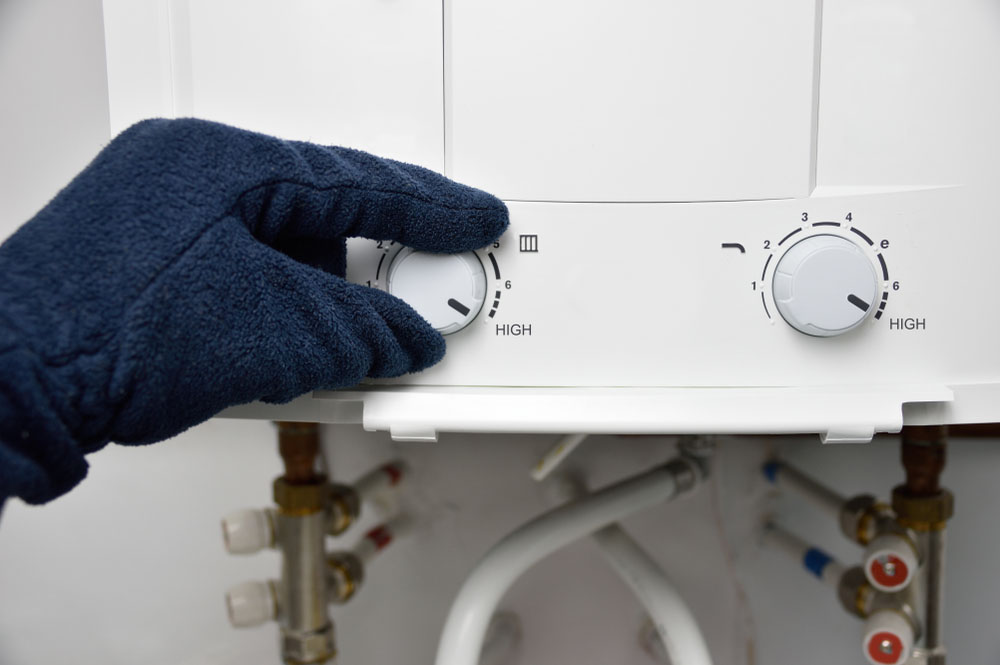 plumber inspecting a tankless water heater