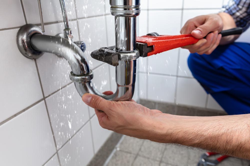 plumber fixing leaking pipe Columbia, MO