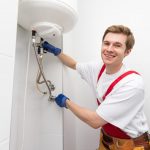 plumber inspecting a water heater Columbia, MO