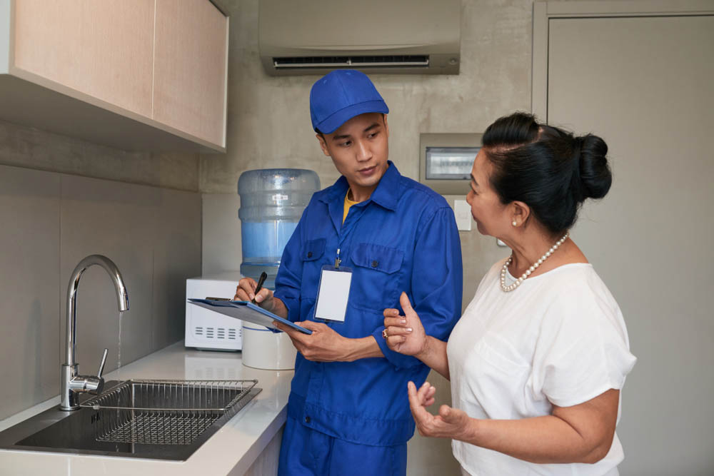 homeowner talking to a plumber